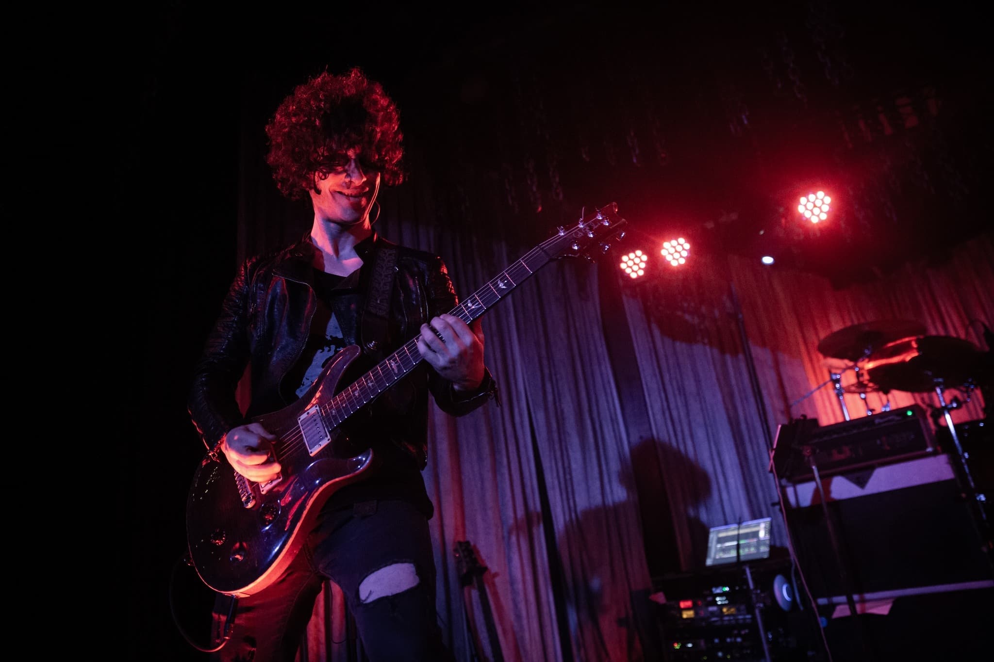 Scott Landes playing guitar on stage